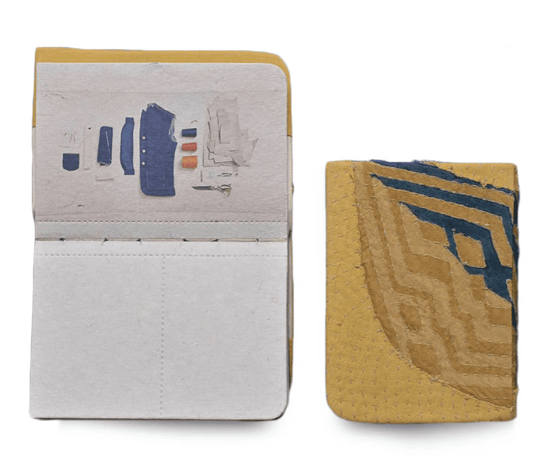 Handmade of book with a kantha cover and papers made from recycled from fabric scraps of undyed cotton, indigo, red and charcoal.